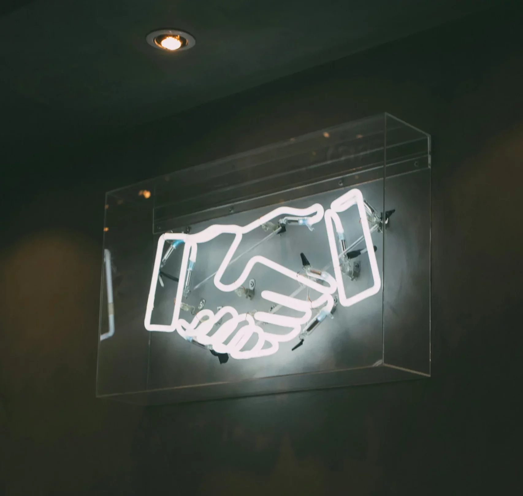 A sign depicting a handshake, showing someone knows how to improve customer communication